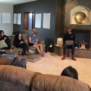 Photo of Lemonheads listening to John T. Meyer at retreat