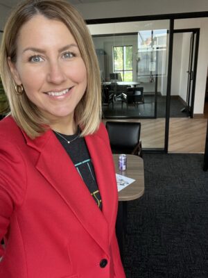 Photo of Natalie Eisenberg standing in her office at Lemonly HQ