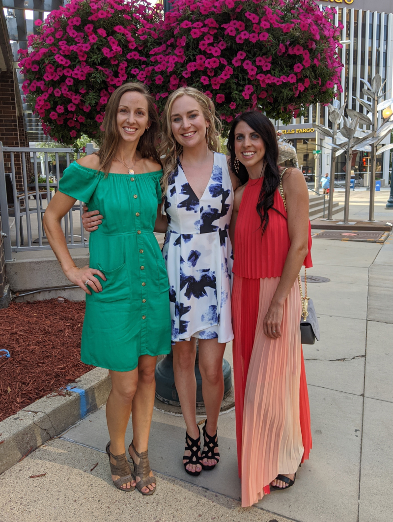 Cortney posing with friends in downtown Sioux Falls