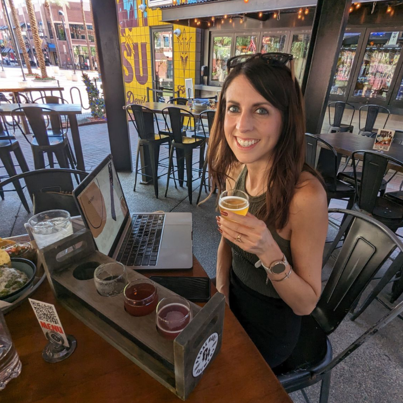 Cortney working from a sunny outdoor brewery